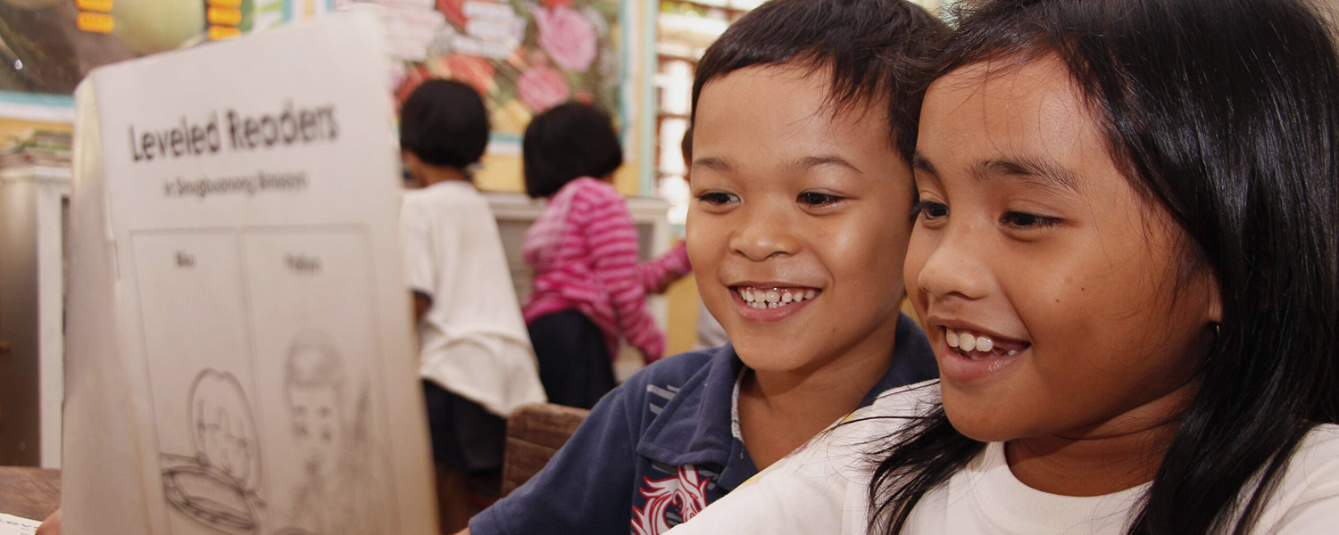 Students in the Philippines reading a book