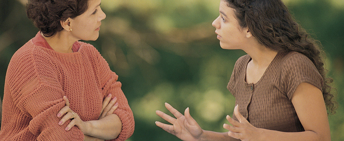 A teenager talking with her mother.