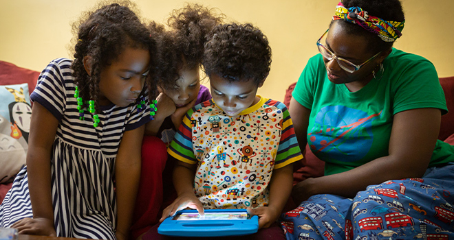 A photo of a family engaged in a science activity