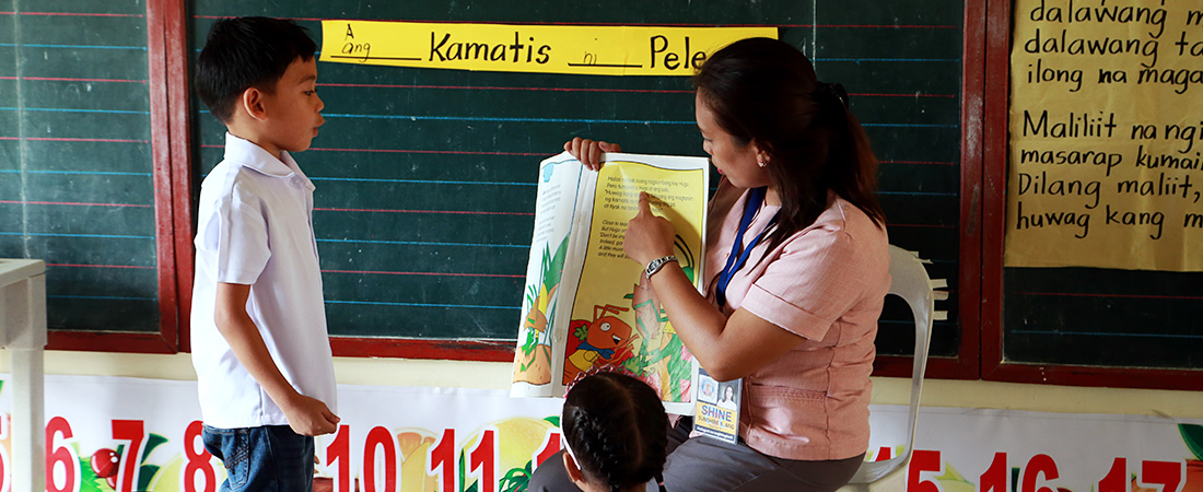 A photo of teacher and student from Basa Pilipinas program