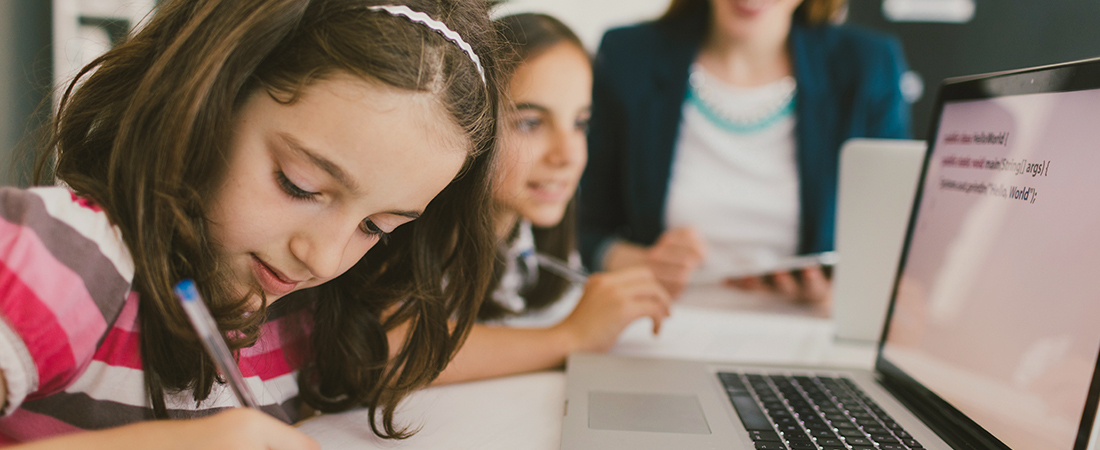 A photo of students using a computer representing A New Language for Mathematics