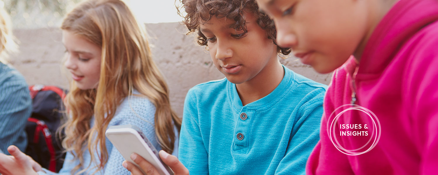 A photo of tweens using technology