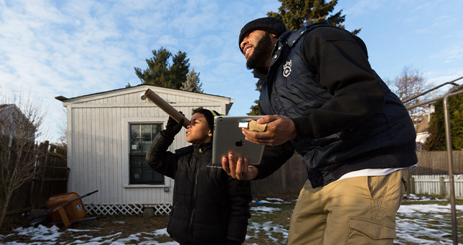 A photo of a family engaged in a science activity