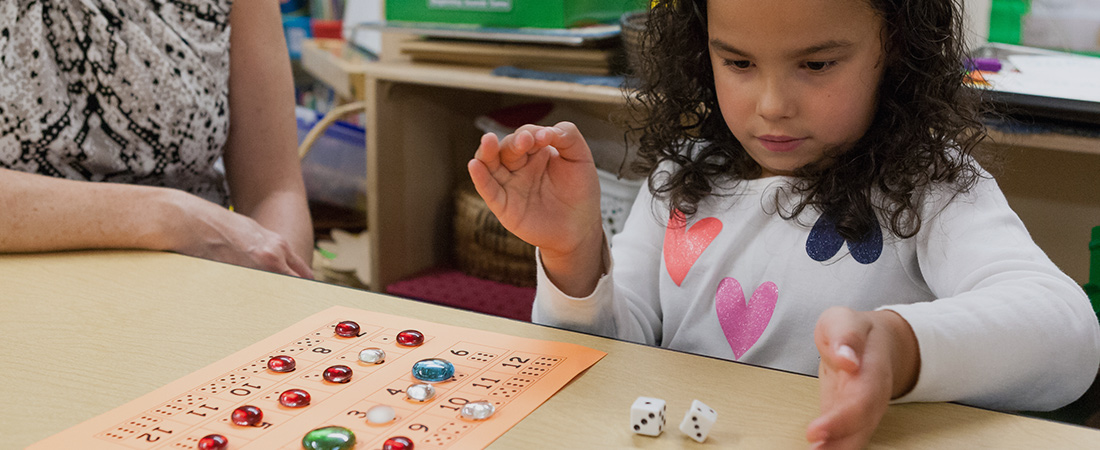 A photo of a preschooler playing a math game