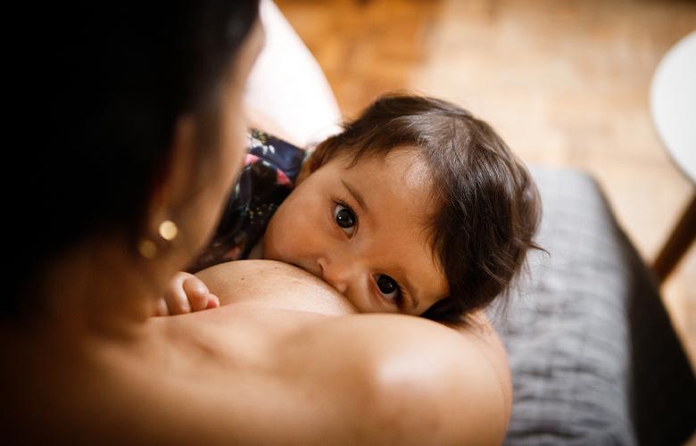 A  photo of a child breastfeeding 