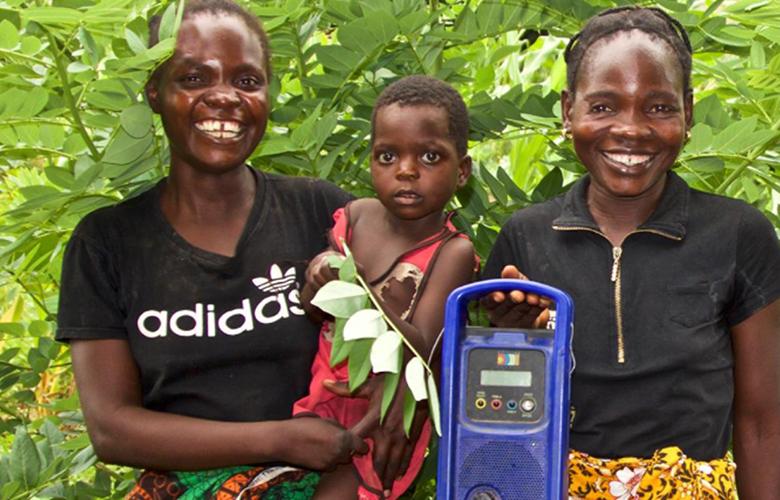 A photo of parents and child with a radio