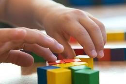 A student using blocks to solve a math problem.