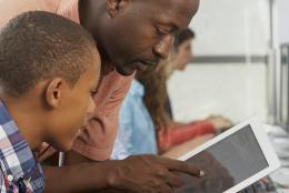 Students and teacher using a computer.