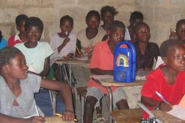 Students in Malawi listening to a radio