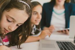 A photo of students using a computer representing A New Language for Mathematics