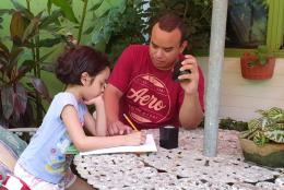 A photo of parent and child learning at home representing International Literacy Day—September 8