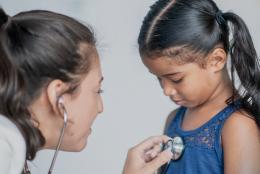 A photo of a doctor and child patient