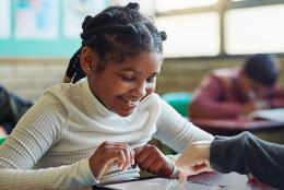 A photo of a teacher and student representing Taking Stock of Learning Loss