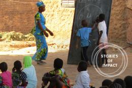 A photo of students and teacher representing Reading Inspires Students, Parents in Mali