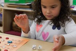 A photo of a preschooler playing a math game